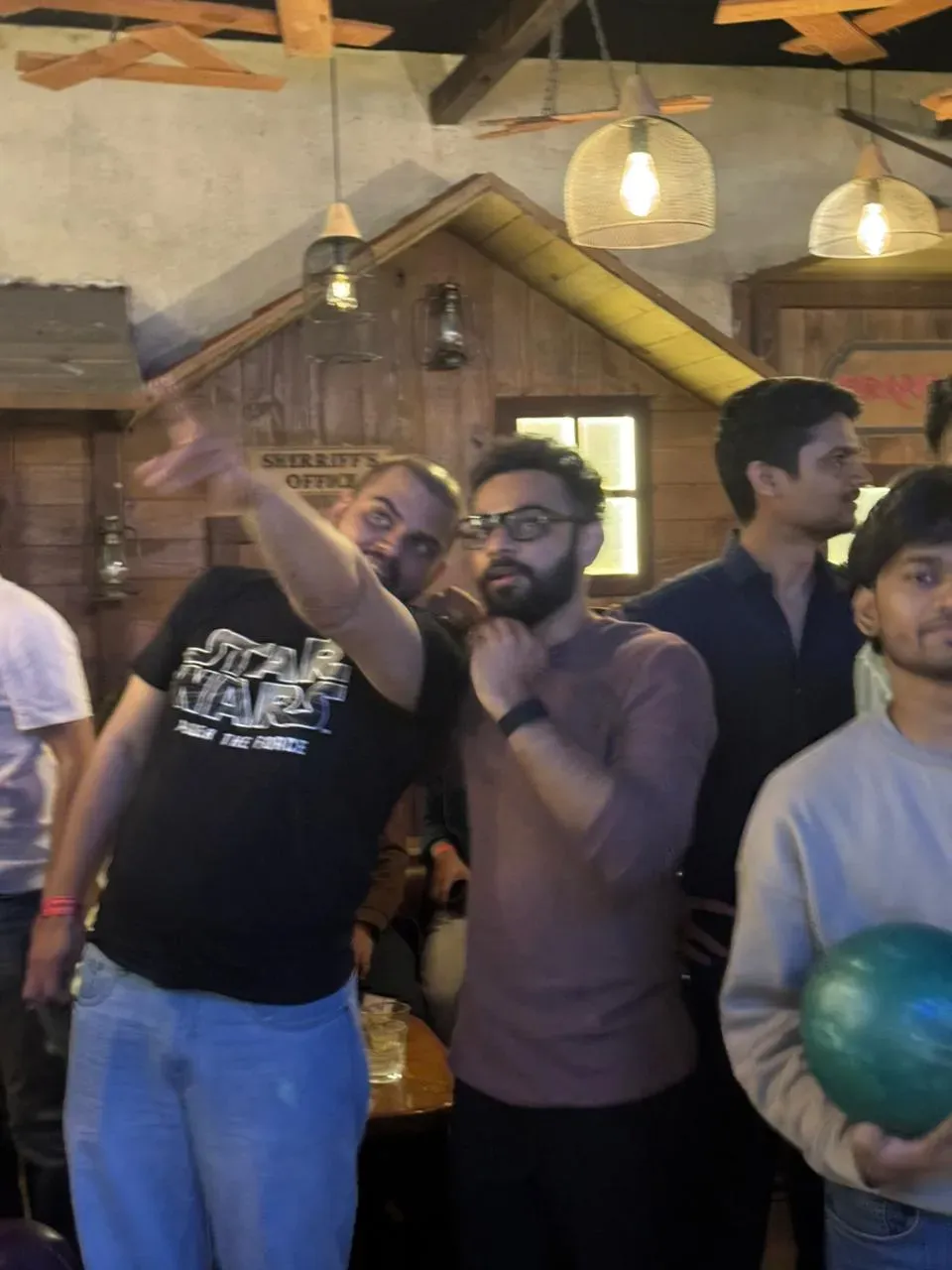 Colleagues waiting for their turn to bowl