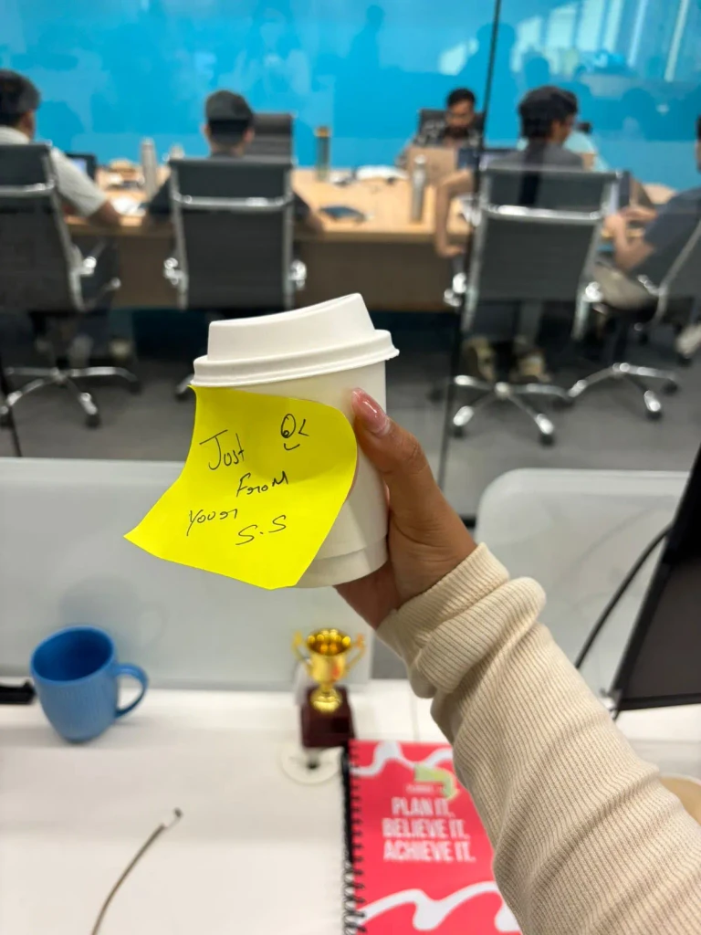 Team member smiling with a present